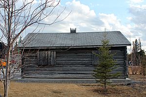 A longer face of the same building, with two shuttered windows