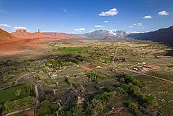 Castle Valley sits next to Castleton Tower, Round Mountain, and in the distance, the La Sal Mountains.