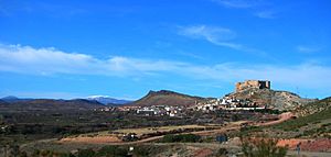 View of Mesones de Isuela town with the Sierra de Nava Alta in the background and the Moncayo Massif covered in snow in the distance.