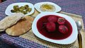 Red Kubbeh soup with pita, pickled cucumbers and hummus