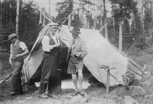 Prince Edward, Prince of Wales speaking with guide in the woods near Nipigon, Ontario