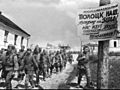Soviet soldiers in Polozk (Belarus), passing by propaganda poster celebrating the reconquest of the city and urging the liberation of the Baltic from Nazi German occupation. July 4, 1944