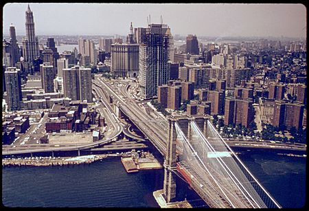 THE BROOKLYN BRIDGE INTO MANHATTAN, NEW YORK TRANSPORTATION IN AN URBAN AND INDUSTRIAL AREA LIKE NEW YORK PRODUCES... - NARA - 555733 color balance