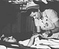Navy Nurse cares for a wounded serviceman aboard USS Haven during Korean War