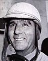 black and white photo of Nino Farina wearing an open faced helmet