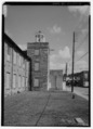 DETAIL VIEW OF SOUTH SIDE OF NORTH STAIR TOWER. GRANITE STRUCTURE IN BACKGROUND IS THE 'PICKER HOUSE' AREA EXPANDED IN THE 1940s. - Graniteville Mill, Marshall Street, Graniteville HAER SC,2-GRANV,1-4