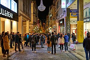 Ermou Street in the evening. In the distance the Byzantine Church of Panagia Kapnikarea