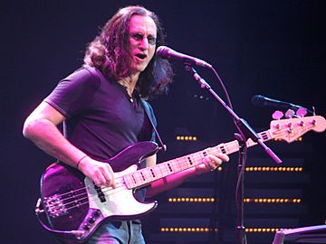 Geddy Lee playing his Fender Jazz Bass and singing at a 2008 live performance at the Xcel Energy Center