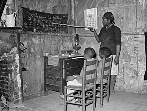 Mother teaching children numbers and alphabet in home of sharecropper, Transylvania, Louisiana, 8b37034