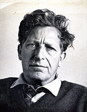 Portrait of a man with unkempt hair with a sweater over a shirt and tie