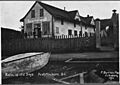 Post card. "Relic of old days. Port Simpson, B.C." 3 unidentified men standing on porch of Hudson's Bay Company... - NARA - 297312