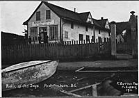 Post card. "Relic of old days. Port Simpson, B.C." 3 unidentified men standing on porch of Hudson's Bay Company... - NARA - 297312