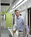 Macri walking into a new, colorful subway car