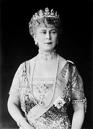 Mary in tiara and gown wearing a choker necklace and a string of pearls