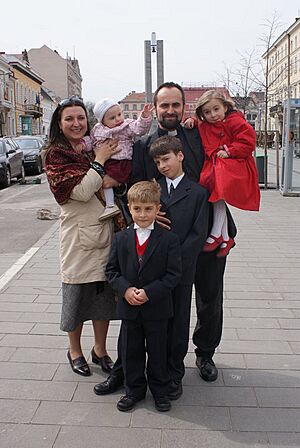 Catholic priest with his Family